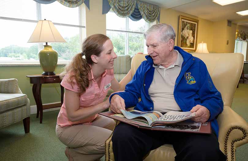 A resident and caregiver in the Memory Care neighbourhood
