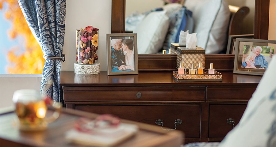 bedside dresser with family photos